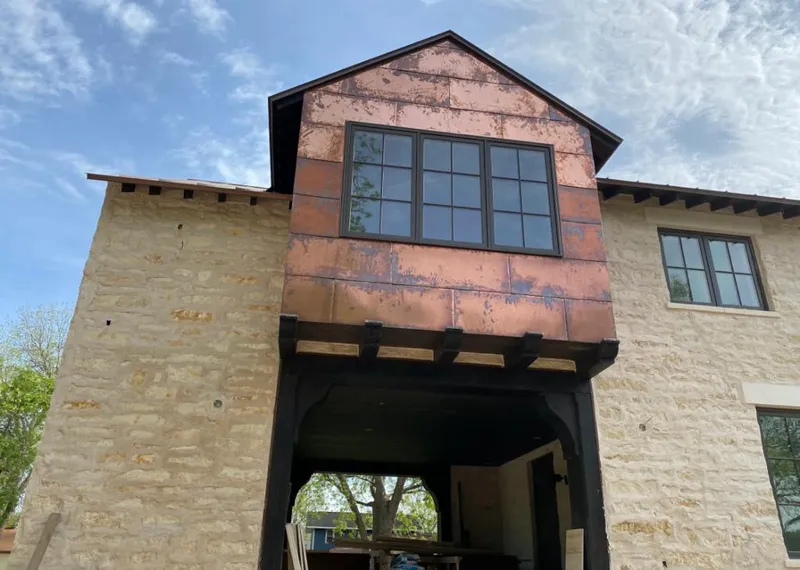 Copper metal panel facade on a stone building for Metal Roof Coating in Texarkana