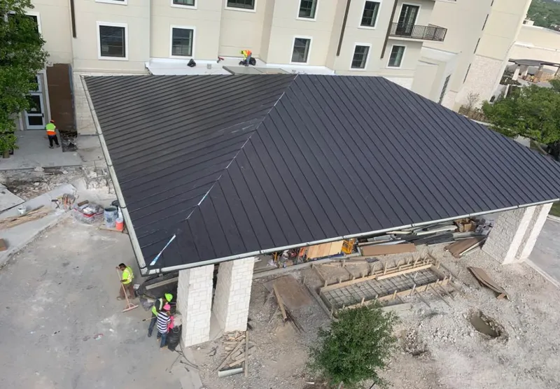Metal roofing installation team working on a commercial building in Texarkana
